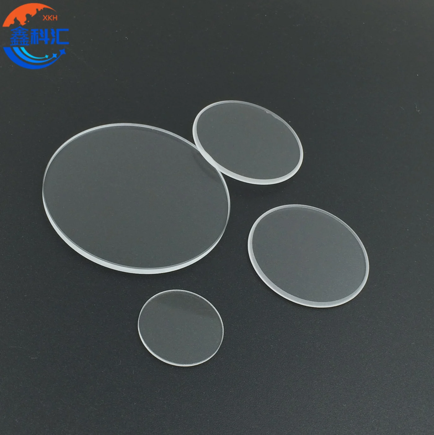 Polished circular calcium fluoride CaF2 optical windows on a dark surface